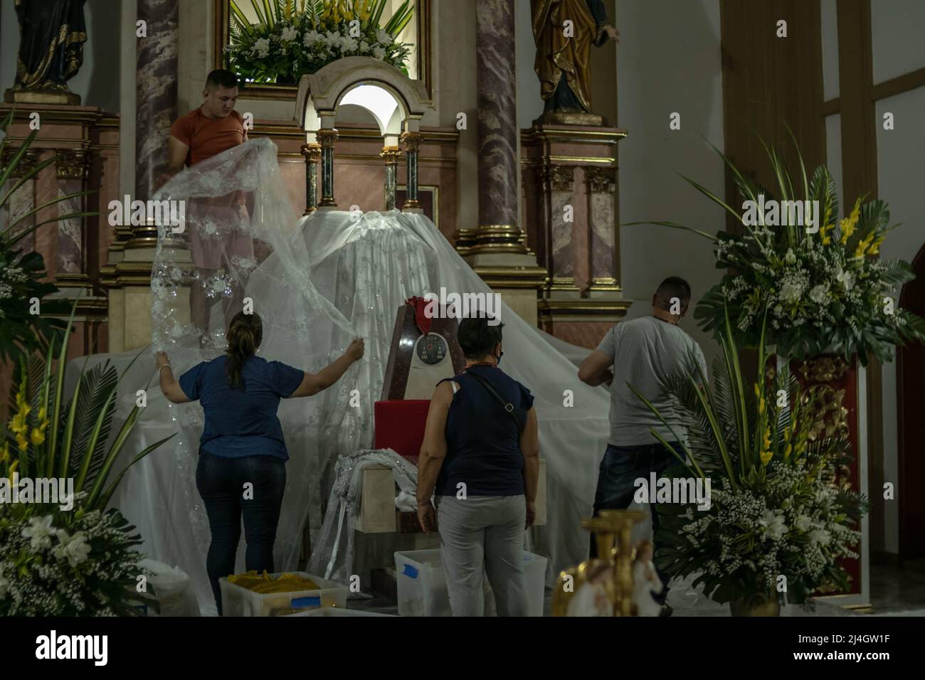 Church volunteers prepare and clean the 'Nuestra Señora del Carmen' Cathedral during preparations for the Sacrament of Eucharist Mass during the holy week celebrations in Colombia in Villavicencio, Colombia on April 13, 2022. Photo by: Mario Toro Quintero/Long Visual Press Stock Photo