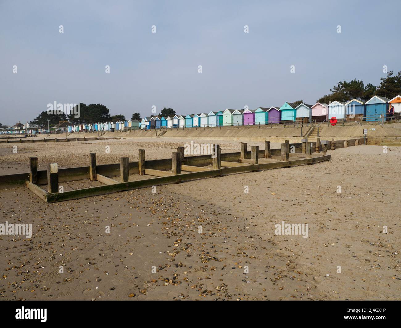 Avon Beach groynes and beach huts, Christchurch, Dorset, UK Stock Photo