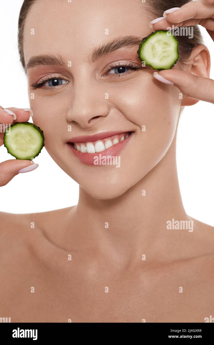 Cucumber mask for female smooth skin face. Skin care with cucumbers Stock Photo