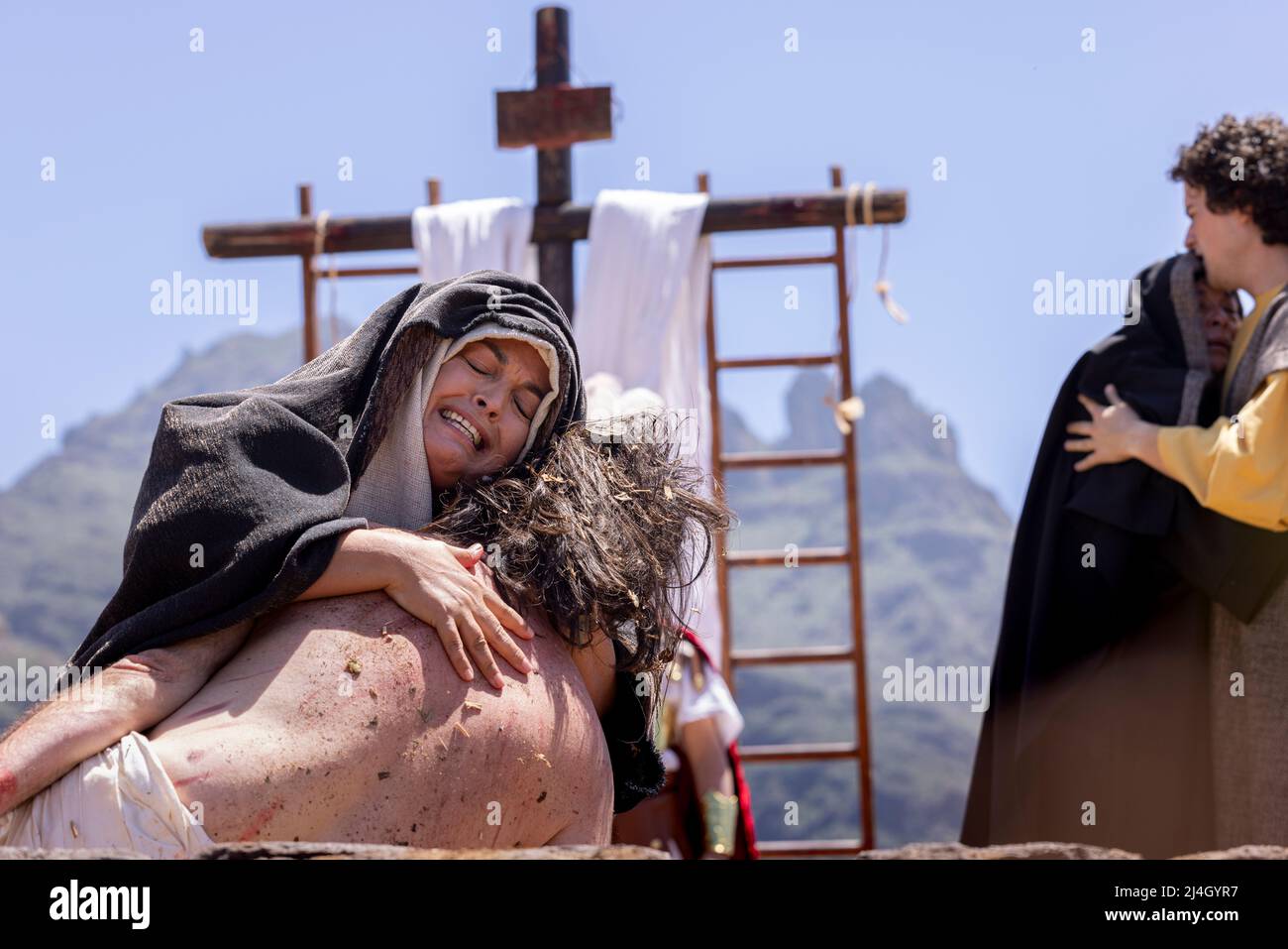 Adeje, Tenerife, Canary Islands, Spain. 15th Apr, 2022. The Good Friday Passion Play returns to Adeje after two years of not happening due to the Covid 19 pandemic. The spectacle is transmitted live to the whole of Spain and this year for the first time involved a film telling the story of the first part followed by the final act of the crucifixion held live in the Plaza de España, Adeje. Stock Photo
