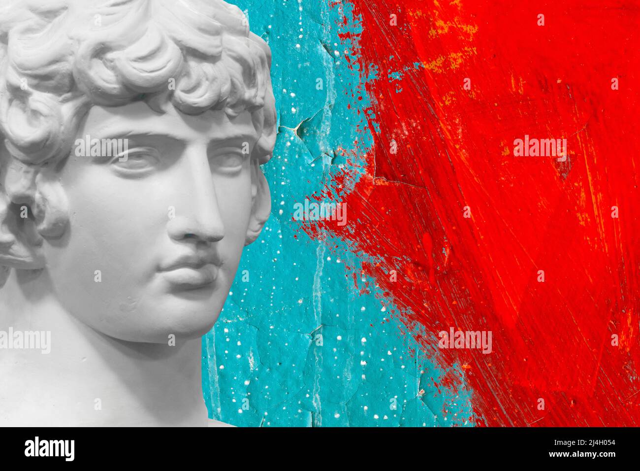 white plaster statue against a wall with red and blue paint. High