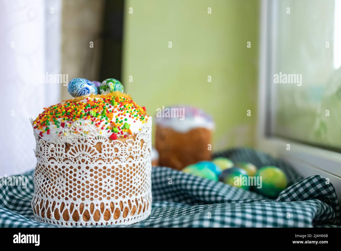 Easter cake with glace icing and easter eggs on black background. Stock Photo