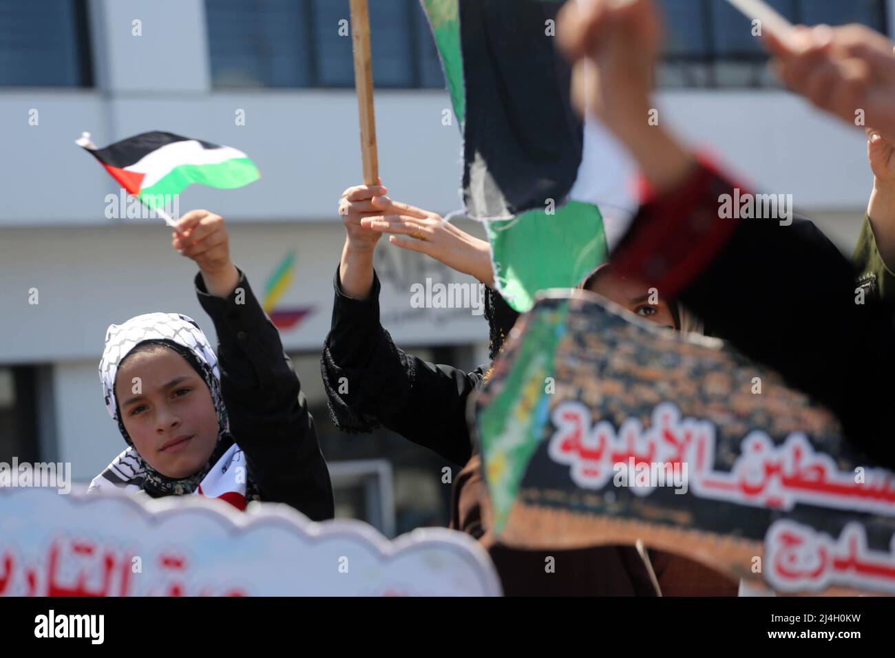 Gaza, Palestine. 15th Apr, 2022. A Palestinian girl waves a Palestinian flag during the demonstration. Palestinians protest against the Israeli policemen who attacked the Palestinians offering their prayers at Al-Aqsa mosque in the Old city of Jerusalem. Al-Aqsa mosque Credit: SOPA Images Limited/Alamy Live News Stock Photo