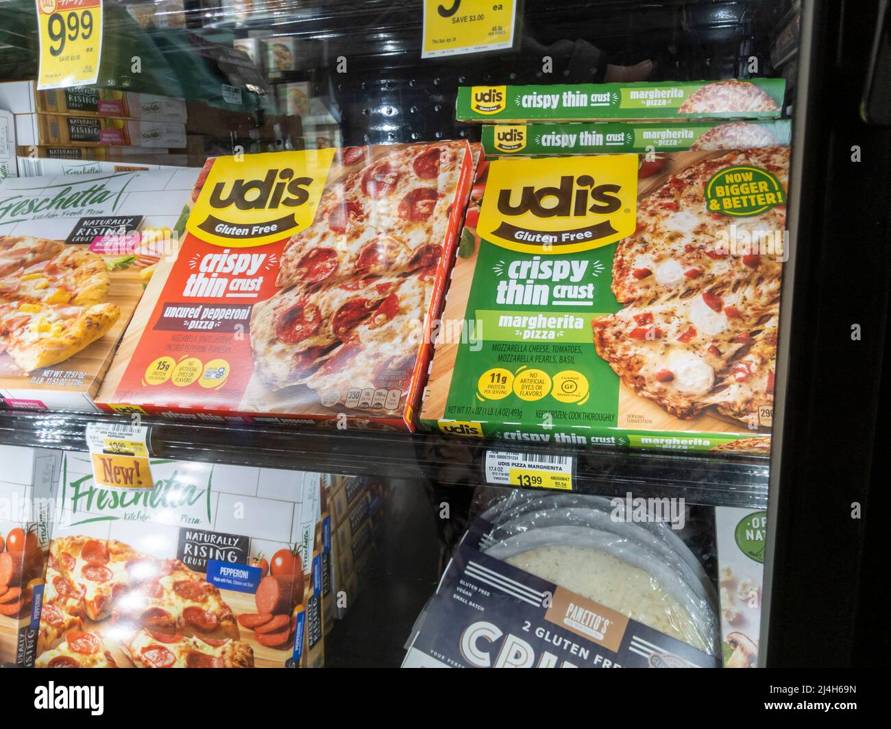 Woodinville, WA USA - circa April 2022: Angled view of Udi's brand gluten free pizzas for sale inside the freezer section of a Haggen grocery store. Stock Photo