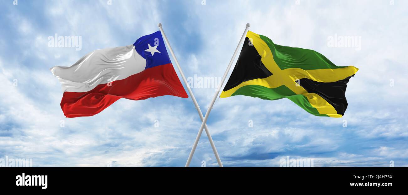 crossed national flags of Chile and Jamaica flag waving in wind at ...
