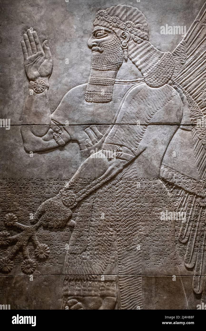Assyrian sculpture of a bearded genii Stock Photo