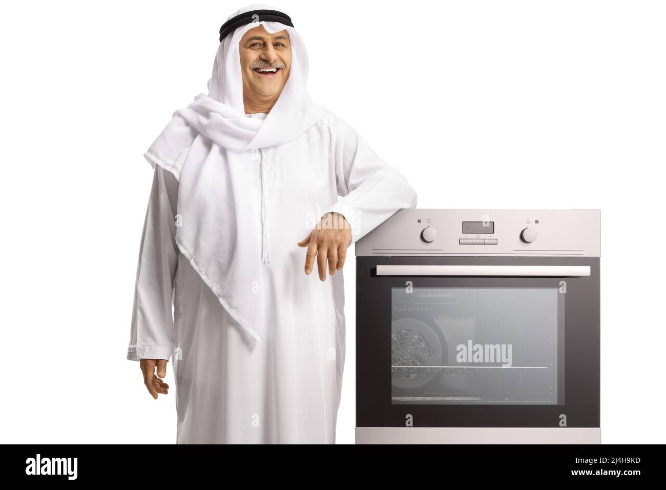 Mature arab man leaning on a built in oven and smiling isolated on white background Stock Photo