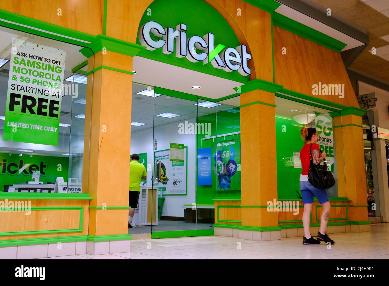 Selinsgrove, Pennsylvania, USA. 14th Apr, 2022. A woman walks by a Cricket Wireless store at the Susquehanna Valley Mall. (Credit Image: © Paul Weaver/SOPA Images via ZUMA Press Wire) Stock Photo