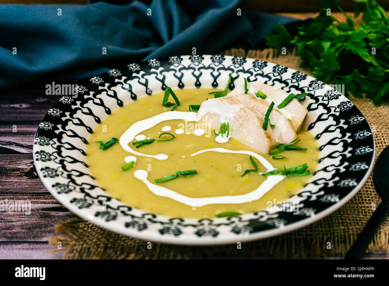 Exquisite vintage dish with a homemade cream of poultry soup in a rustic or country setting. Natural and sensible food concept. Normal View Stock Photo