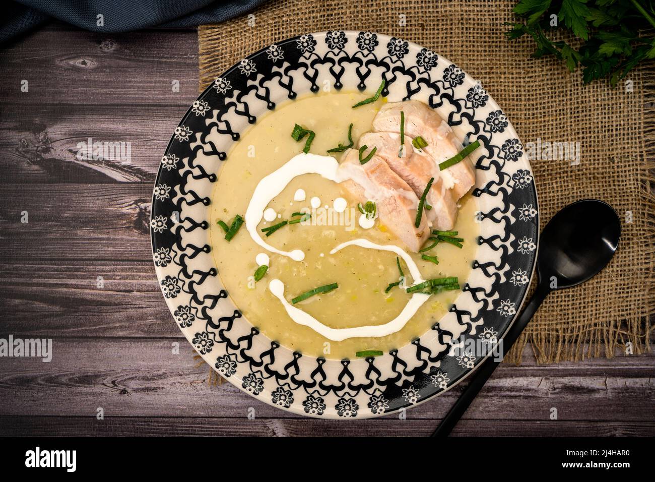 Exquisite vintage dish with a homemade cream of poultry soup in a rustic or country setting. Natural and sensible food concept. Top View Stock Photo