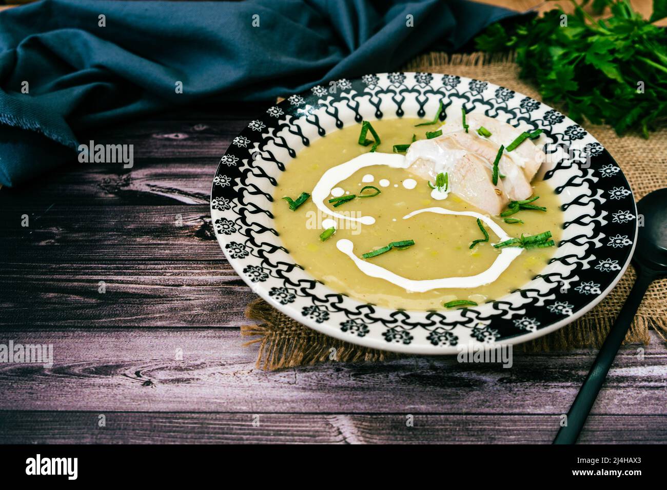 Exquisite vintage dish with a homemade cream of poultry soup in a rustic or country setting. Natural and sensible food concept. high view Stock Photo