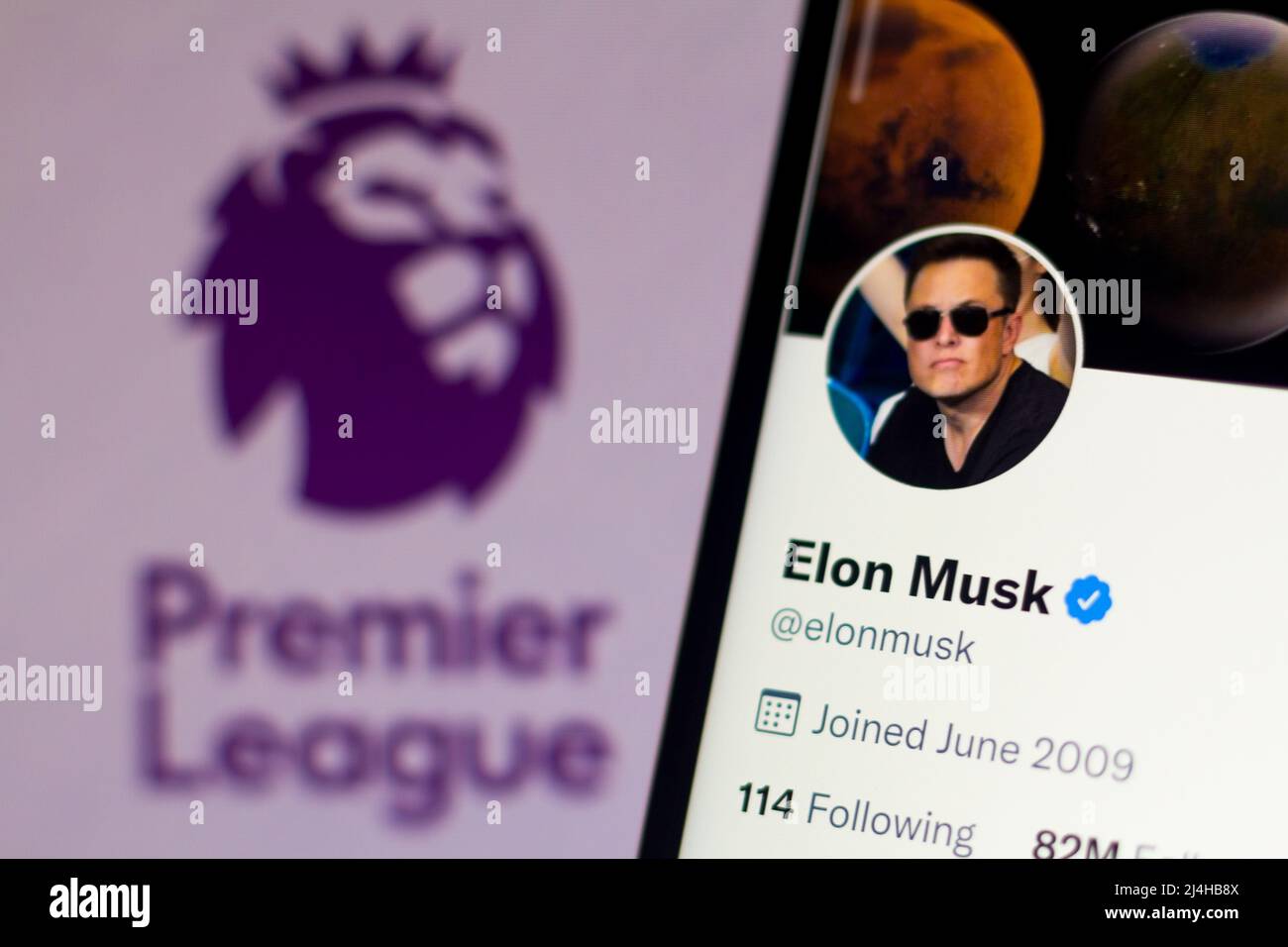 In this photo illustration, the official profile of Elon Musk on the social network Twitter and in the background, the Premier League logo. Stock Photo