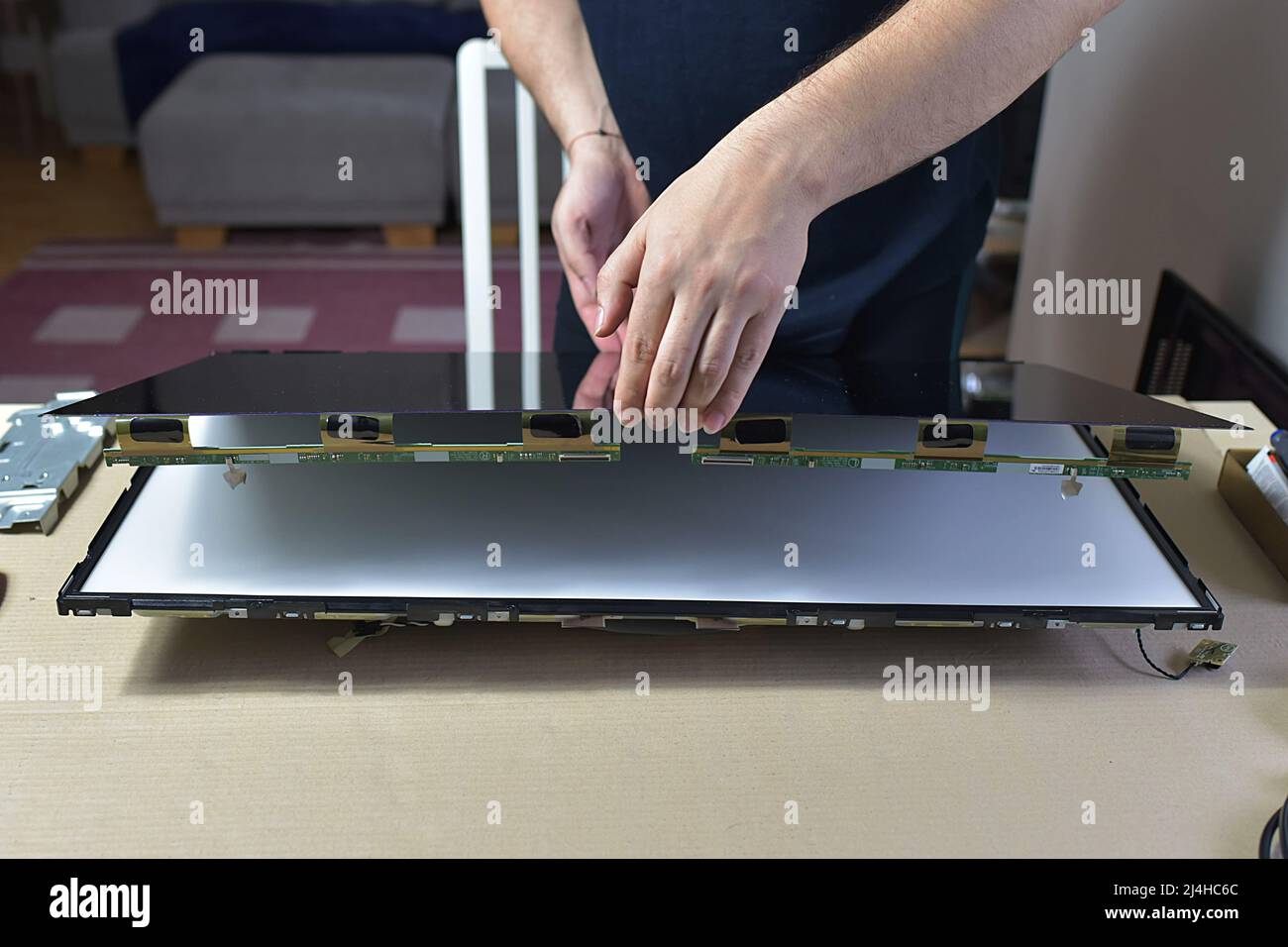 The man repairing broken tv Stock Photo Alamy