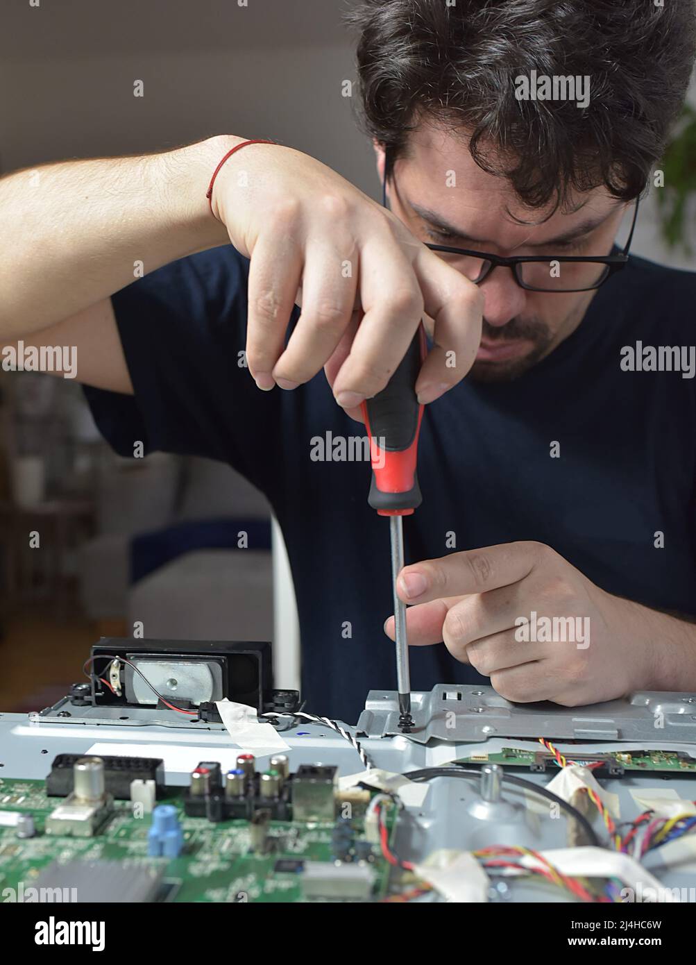 The man repairing broken tv Stock Photo Alamy