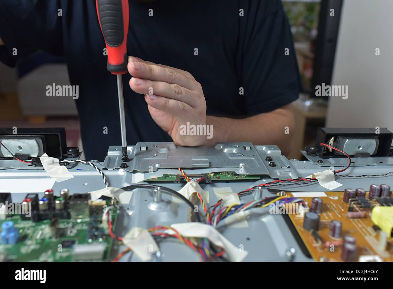 The man repairing broken tv Stock Photo Alamy