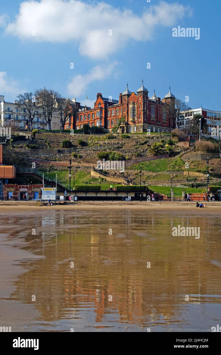 UK, North Yorkshire, Scarborough, Town Hall, St Nicholas Gardens and Foreshore Road from South Bay Beach at low tide. Stock Photo