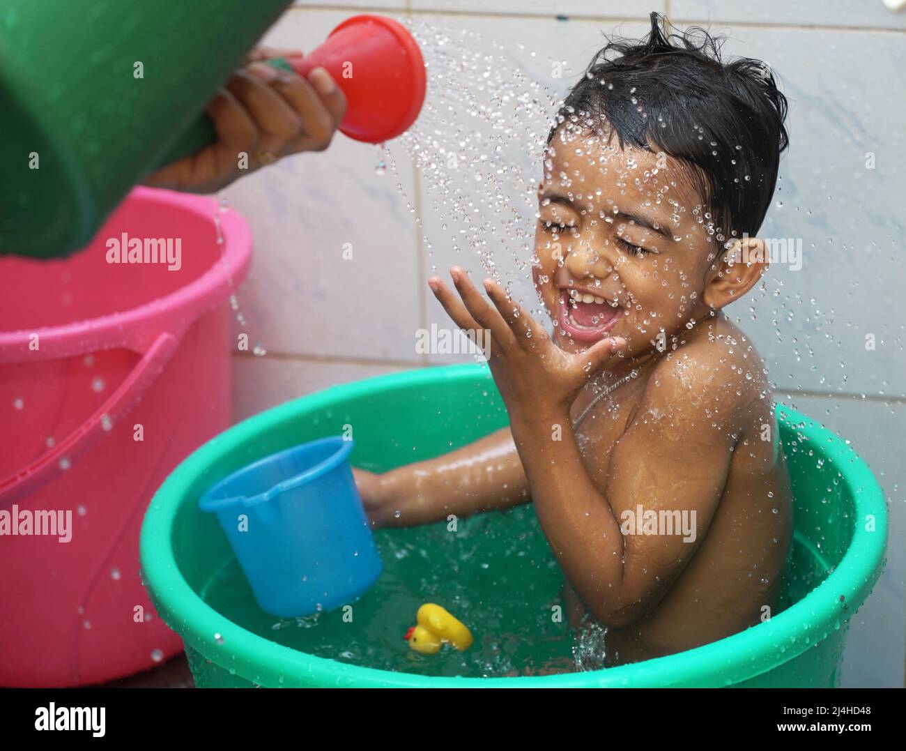 a sweet baby boy wet during bathing staring at shower and screaming in