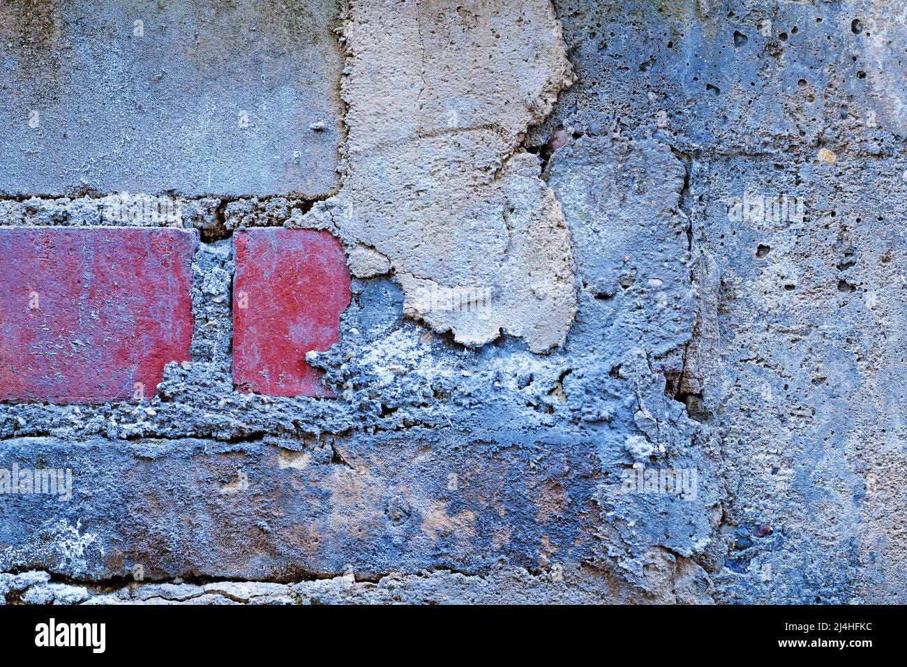 Grunge background with wall with different brick stones and cement Stock Photo