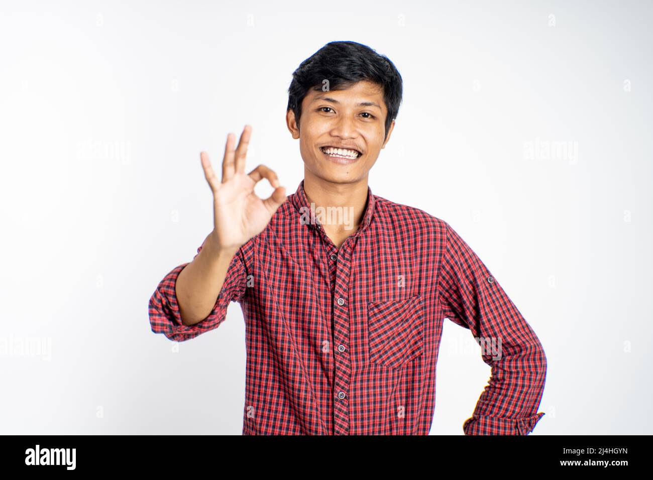 asian young man showing thumbs up with smiling teeth Stock Photo - Alamy