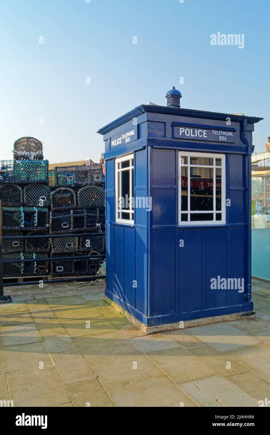 UK, North Yorkshire, Scarborough, Blue Police Telephone Box on Sandside. Stock Photo