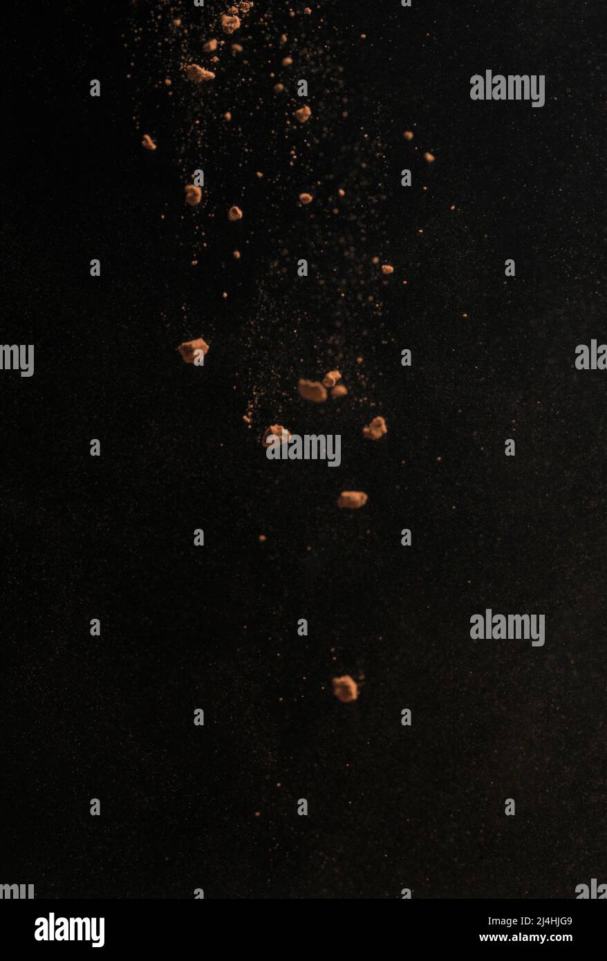 Cocoa powder explosion in motion. Chocolate dust on a black background. Food for food. Isolate