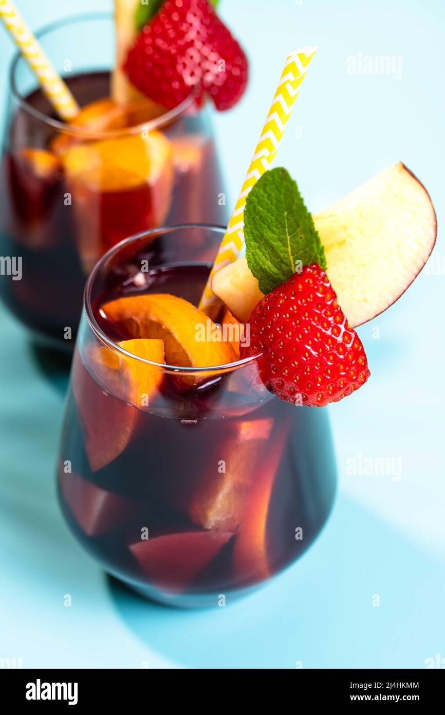 Spanish summer cocktail Sangria served in glasses decorated with fresh