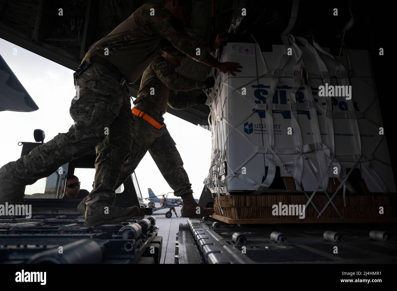 U.S. Airmen load cargo onto an MC-130J Commando II at Al Udeid Air Base, Qatar, Nov. 30, 2021. The MC-130J provides infiltration, exfiltration and resupply of special operations forces and equipment in hostile or denied territory. Secondary missions include psychological operations, and helicopter and vertical lift air refueling. (U.S. Air Force photo by Staff Sgt. Joseph Pick) Stock Photo
