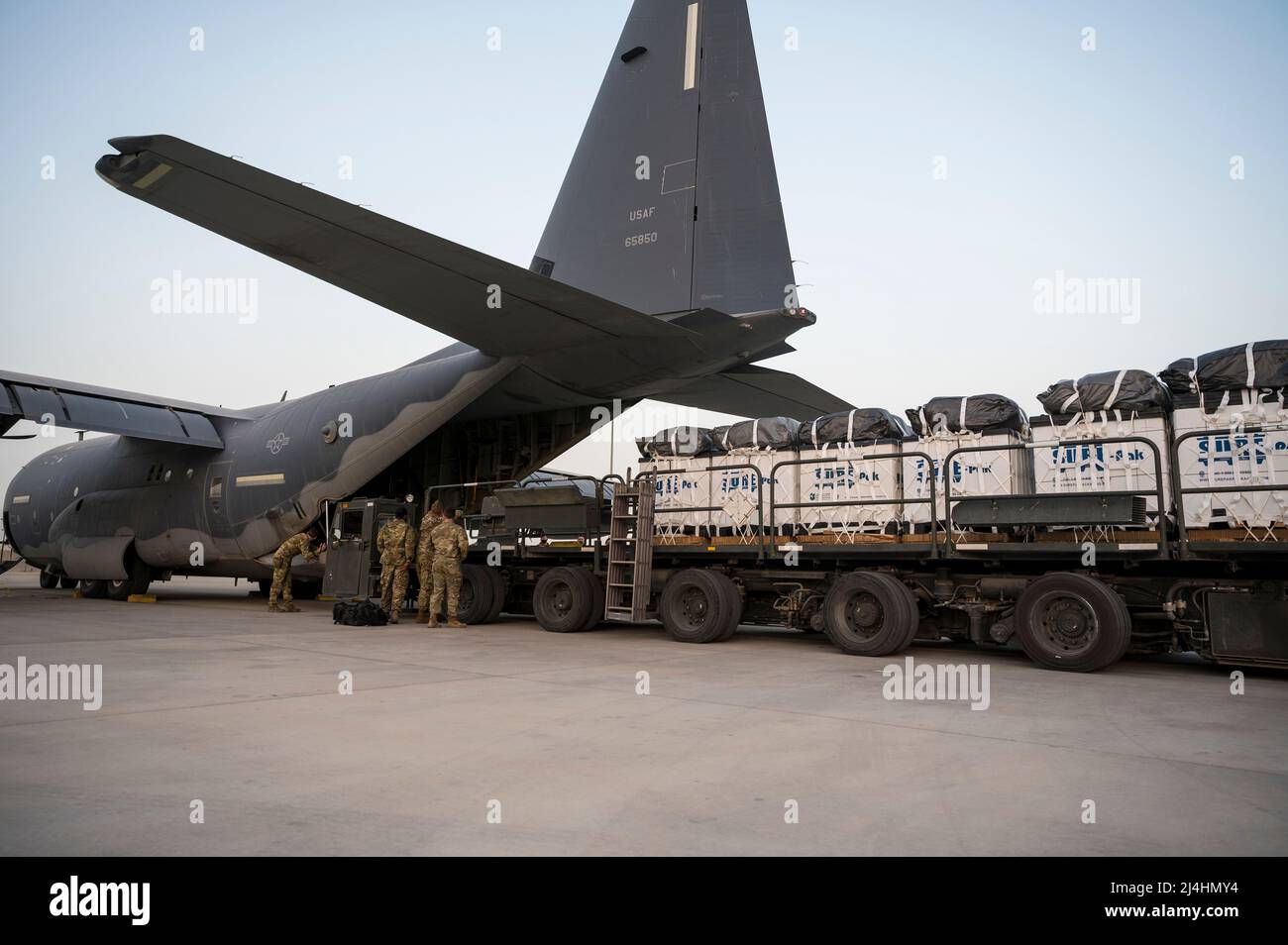 U.S. Airmen load cargo onto an MC-130J Commando II at Al Udeid Air Base, Qatar, Jan. 29, 2022. The MC-130J provides infiltration, exfiltration and resupply of special operations forces and equipment in hostile or denied territory. Secondary missions include psychological operations, and helicopter and vertical lift air refueling. (U.S. Air Force photo by Senior Airman Daniel Hernandez) Stock Photo