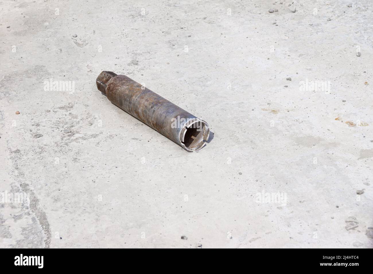 a tubular drill for drilling large holes in concrete lies on a monolithic ceiling, selective focus Stock Photo