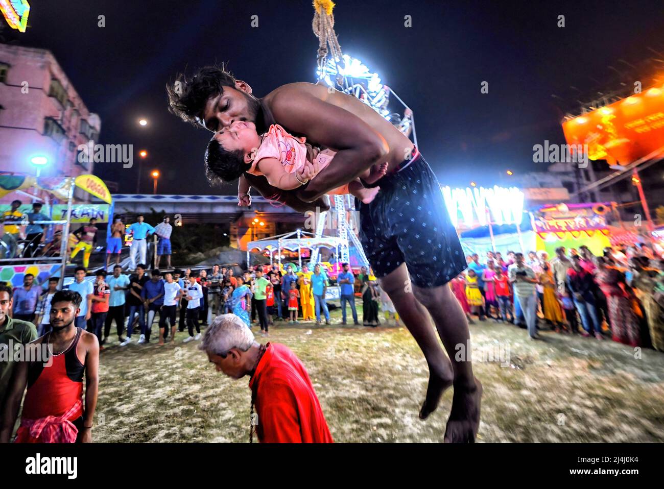 Kolkata, India. 15th Apr, 2022. A Hindu devotee seen hanging with a hook along with a little
