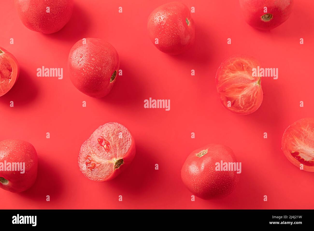 Background with ripe tomatoes on red. Fresh produce Stock Photo