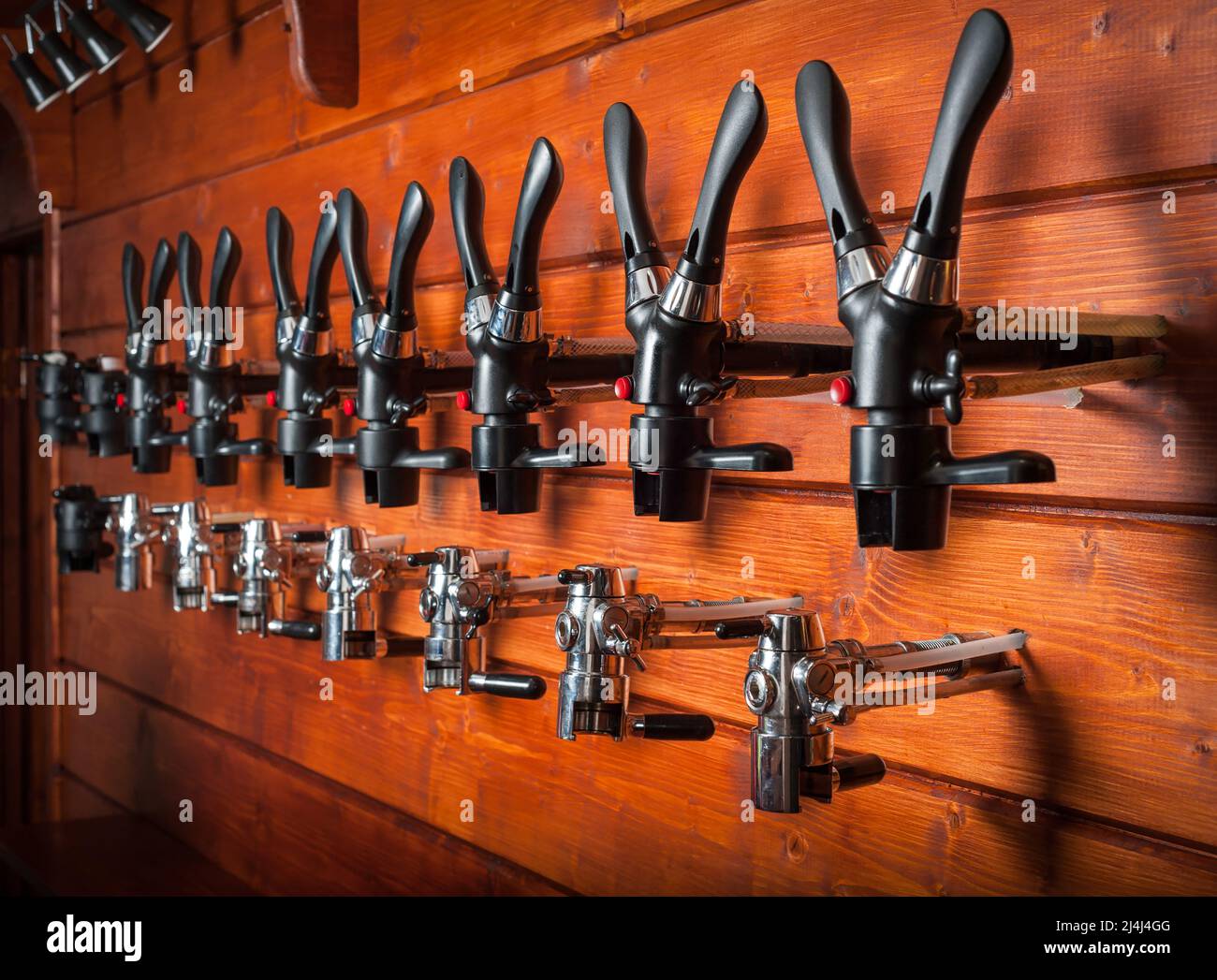 Beer taps for draught drinks are built into wooden boards Stock Photo