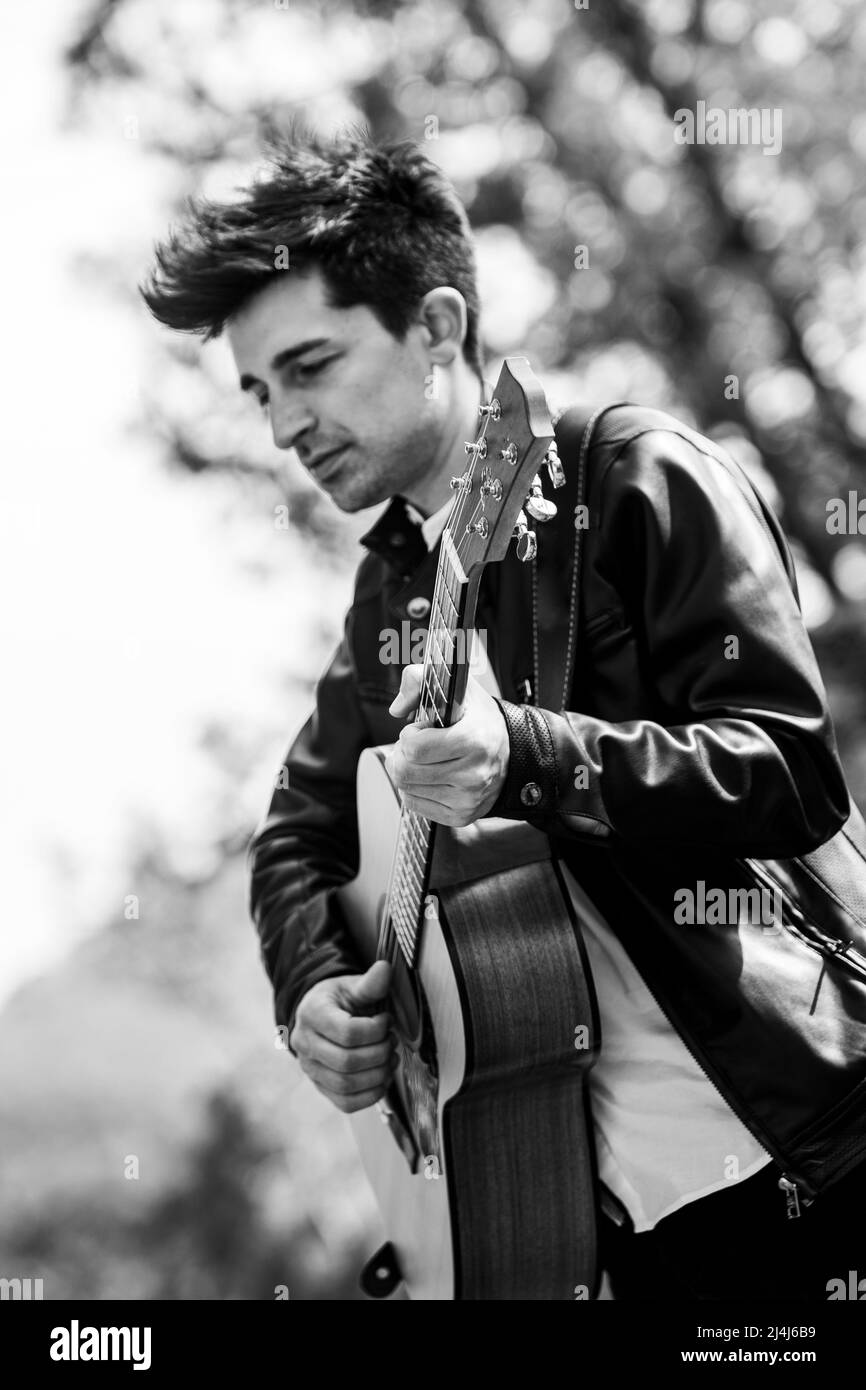 boy plays black and white guitar in nature Stock Photo Alamy