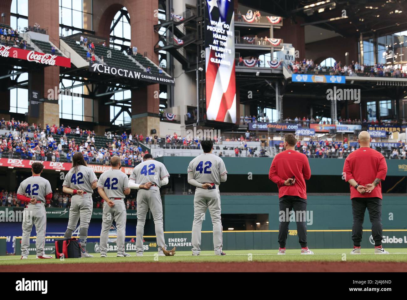 Los Angeles Angels players stand in front of the dugout before a game  against the Texas Rangers at Globe Life Field in Arlington, Texas, on April  15, 2022, wearing Jackie Robinson's No.