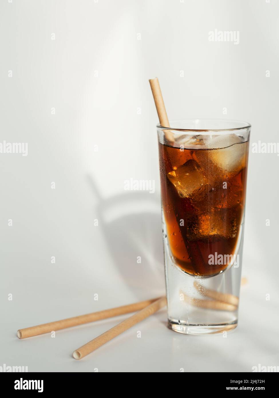 Glass of cola with ice and straw on a white background Stock Photo - Alamy