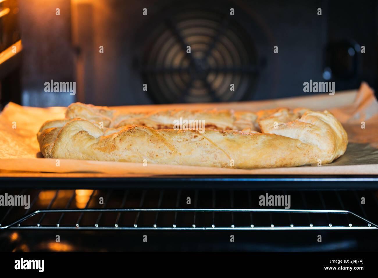 Homemade apple pie baking in oven Stock Photo Alamy