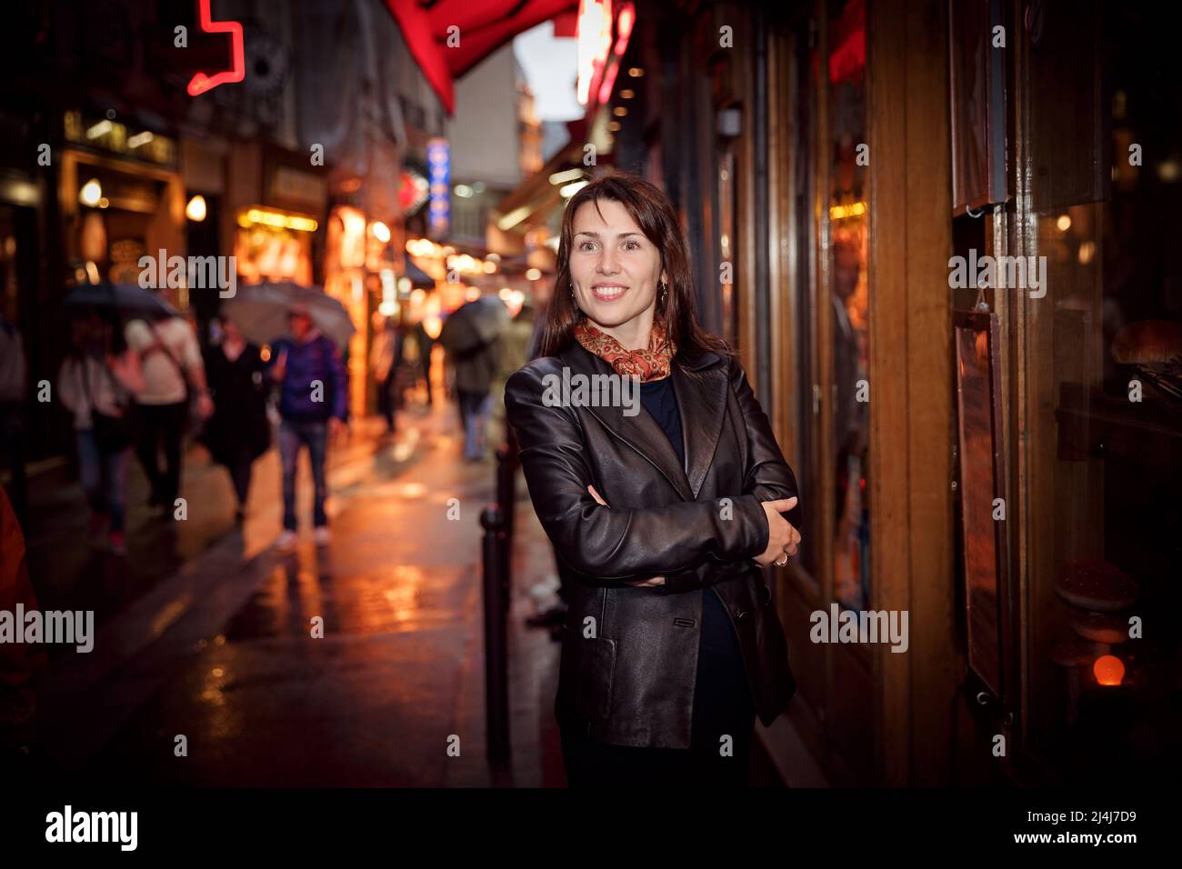 Pretty woman in a black jacket enjoying walking around the city Stock Photo