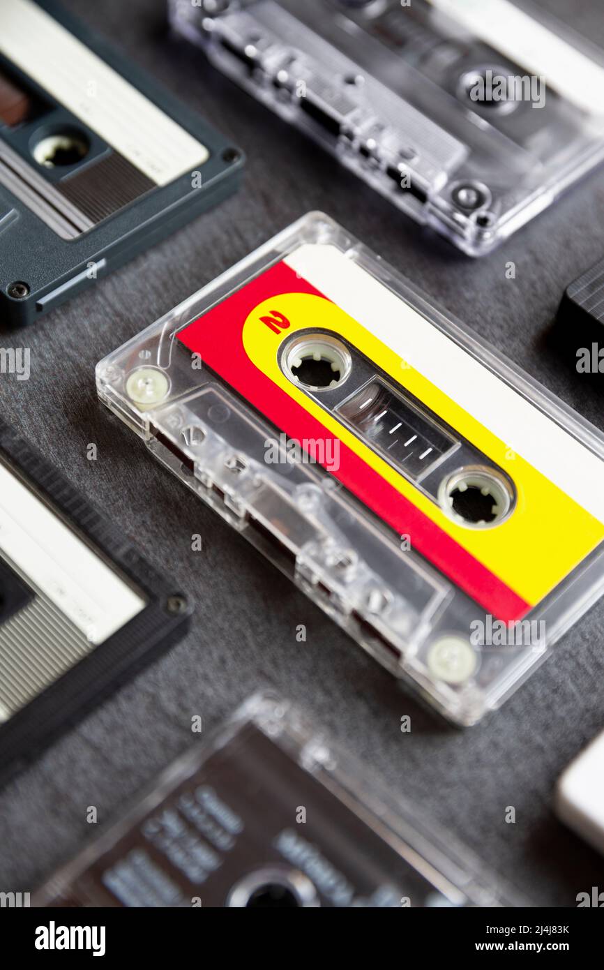 Close up of different old cassette tapes on dark gray background. Music icon of the 80s and 90s. Selective focus. Stock Photo