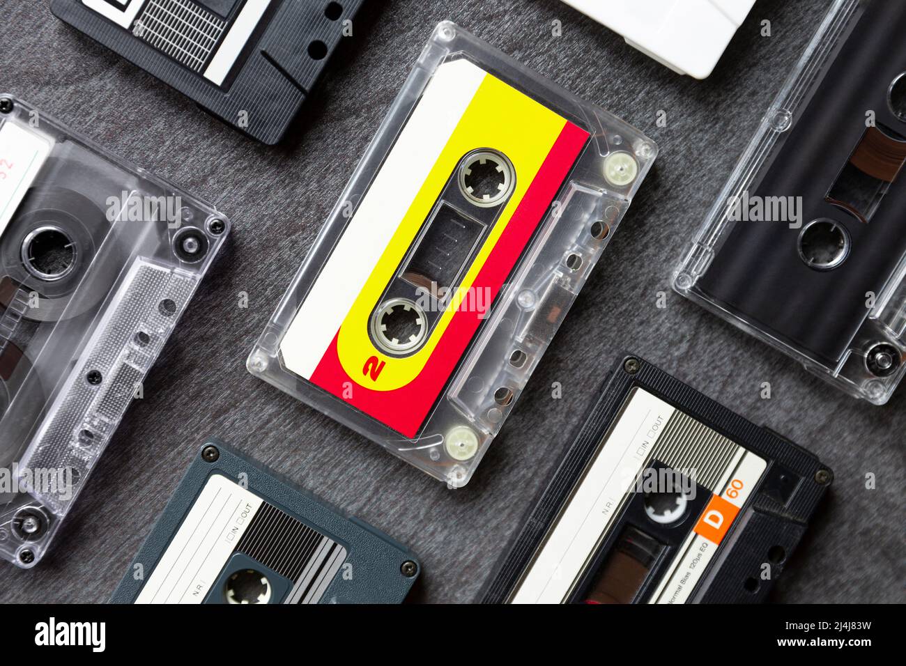 Top view of different old cassette tapes on dark gray background. Music icon of the 80s and 90s. Close up. Stock Photo