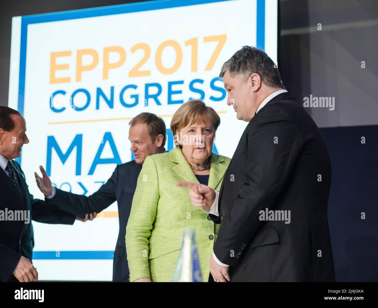 Chancellor of the Federal Republic of Germany Angela Merkel (C) and President of Ukraine Petro Poroshenko (R) during the congress of European People's Party (EPP) in Malta. Stock Photo