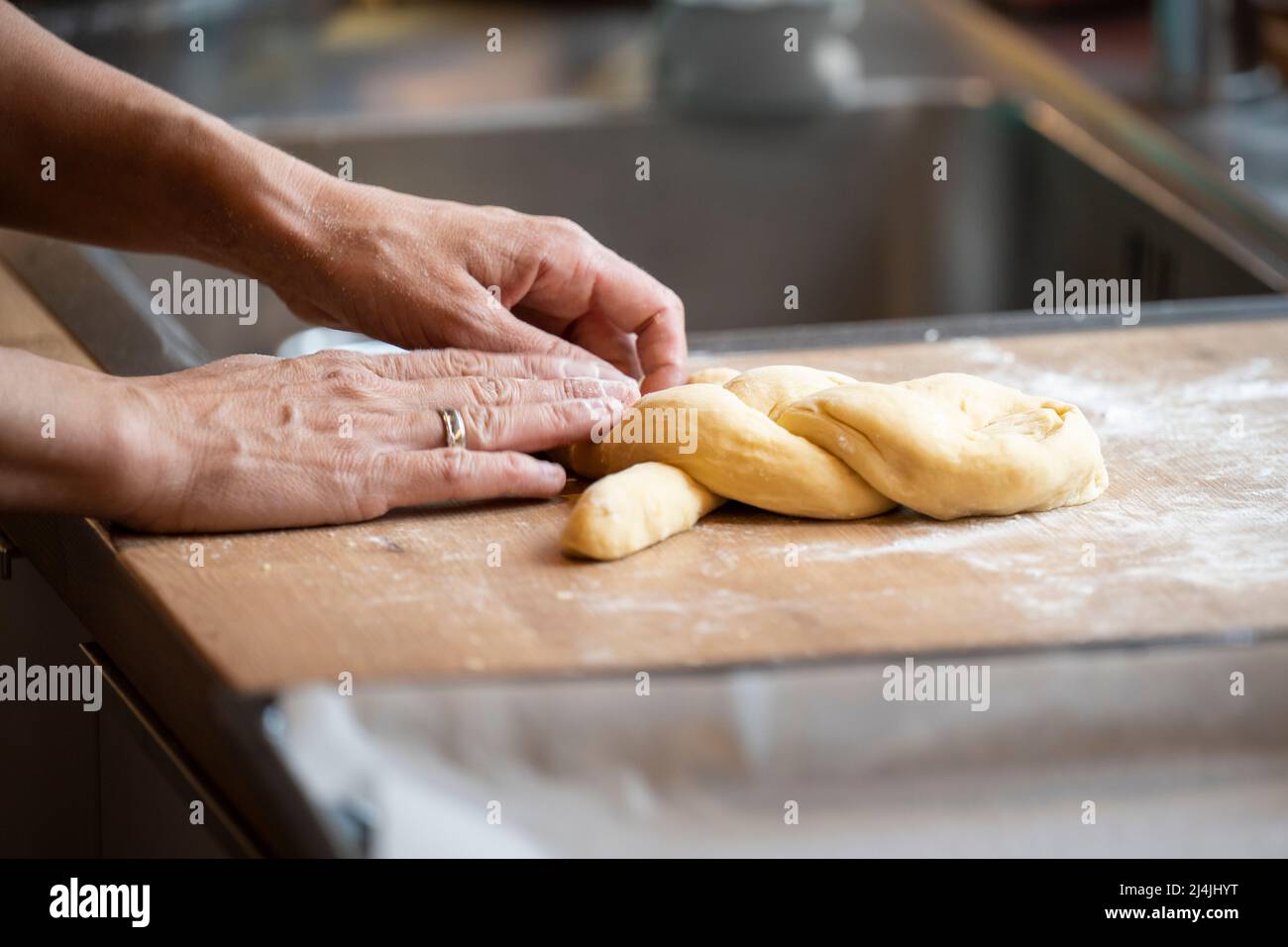 baking handmade easter braid with sweet yeast dough on countertop in kitchen Stock Photo