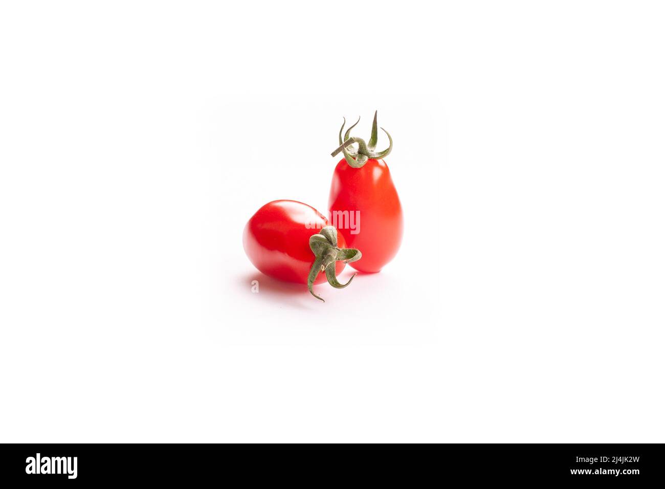 Two little tomatoes on white background Stock Photo