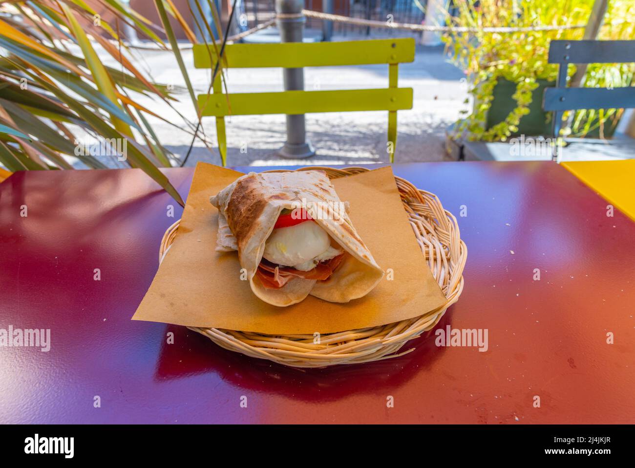 Piada sandwitch in a basket on a table. Stock Photo