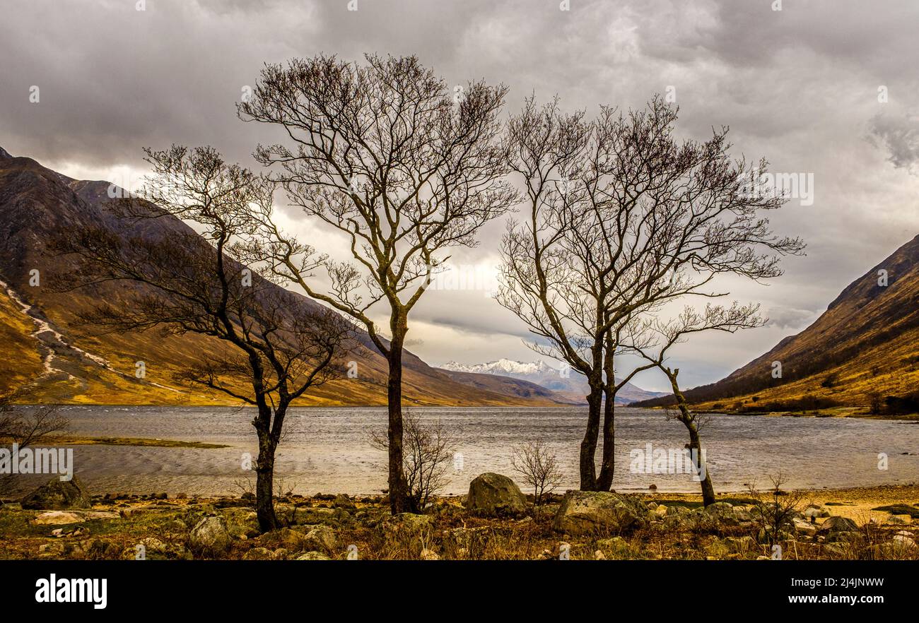 Showery spring weather in Glen Etive at the head of Loch Etive looking towards snow capped Ben Cruachan. Stock Photo