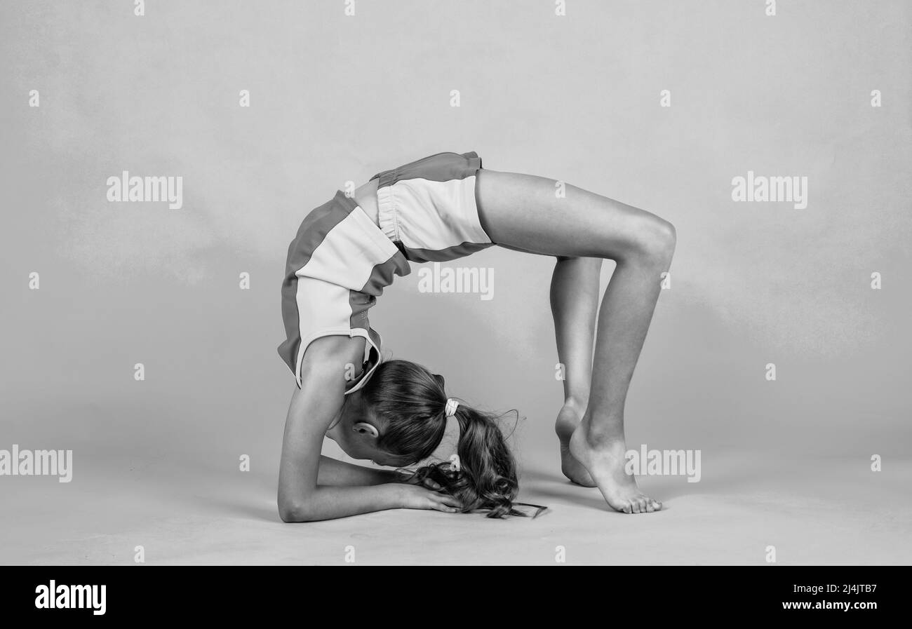 happy kid in sport training clothes workout do bridge pose, acrobatics ...