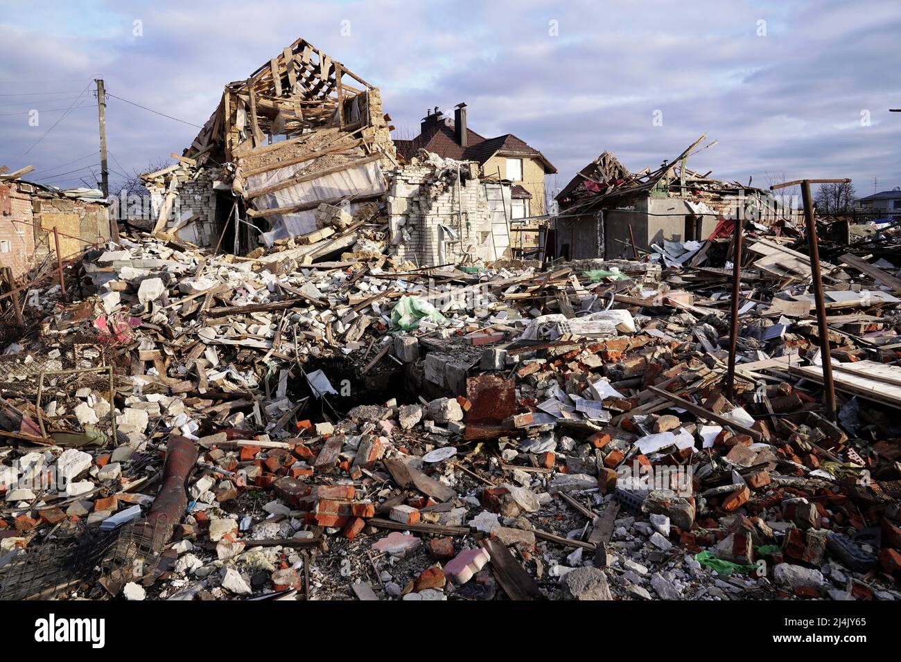 SUMY, UKRAINE - APRIL 14, 2022 - The houses destroyed by Russian shelling lie in ruins, Sumy, northeastern Ukraine. Stock Photo