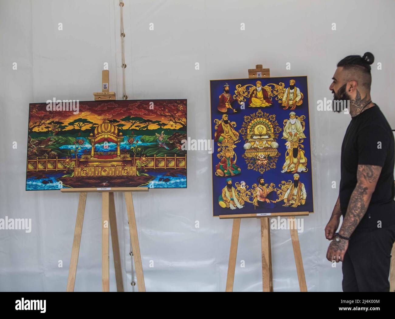 London UK 16 April 2022  Sikh artist Vic Kainth with some of his art work exhibit in  London Trafalgar Square. Today celebrated Vaisakhi , also called Baisakhi, is the festival which celebrates the founding of the Sikh community, the Khalsa, in 1699.Paul Quezada-Neiman/Alamy Live News Stock Photo