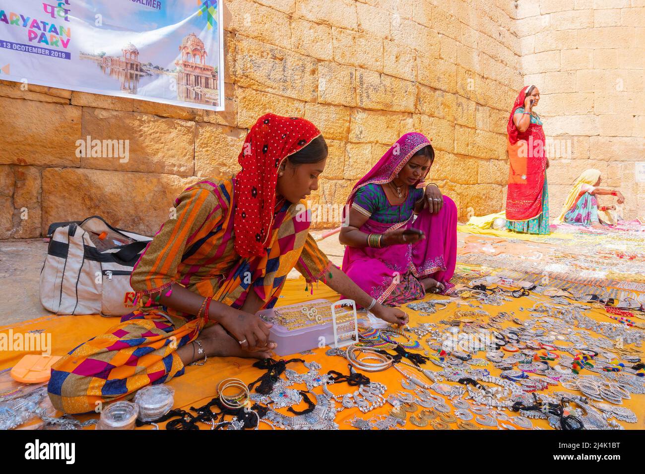 Jaisalmer, Rajasthan, India - October 13, 2019 : Rajasthani women selling jewelleries in market place Inside Jaisalmer Fort . Popular tourist market. Stock Photo
