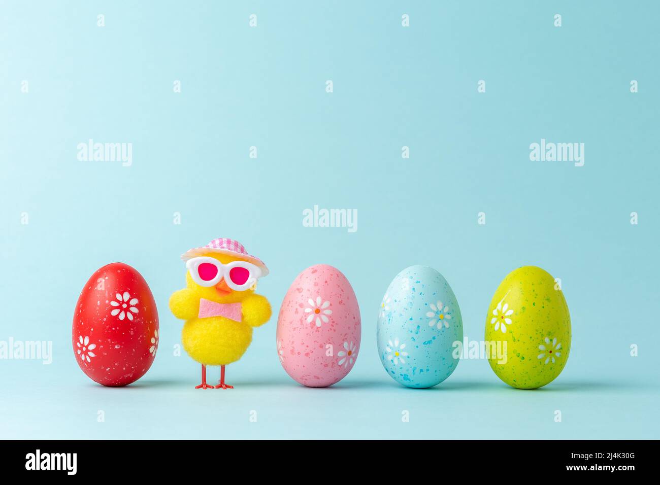 Holiday layout with chicken and colorful Easter eggs. Creative Easter minimal concept. Stock Photo