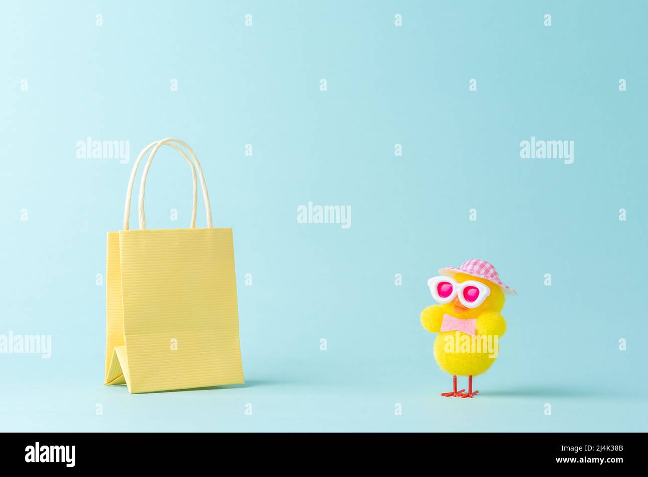 Creative minimal shopping concept made with cute chicken and shopping bag. Spring shopping layout. Stock Photo